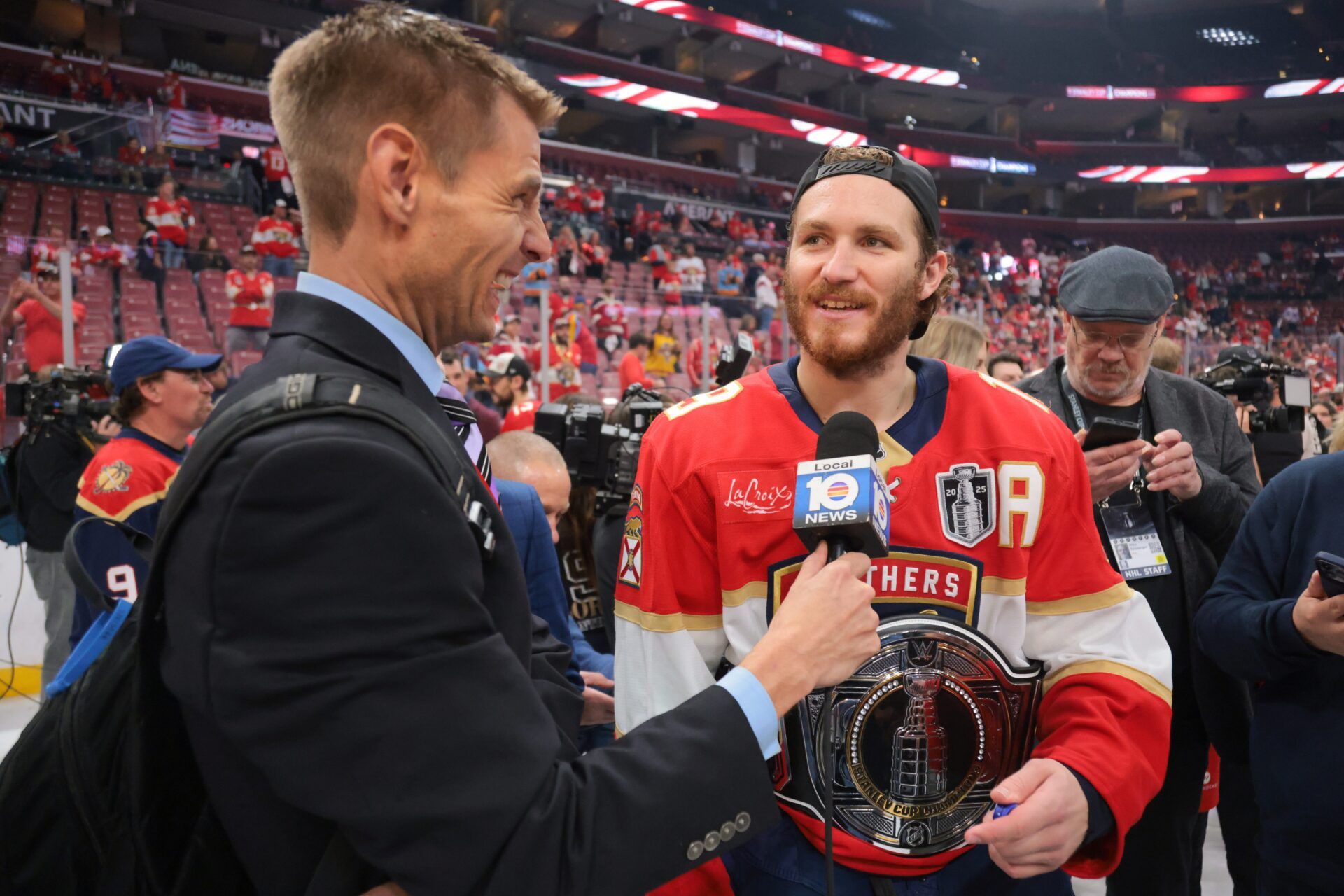 Florida Panthers left wing Matthew Tkachuk (19) is interviewed while wearing an belt after winning game six of the 2025 Stanley Cup Final against the Edmonton Oilers at Amerant Bank Arena.
