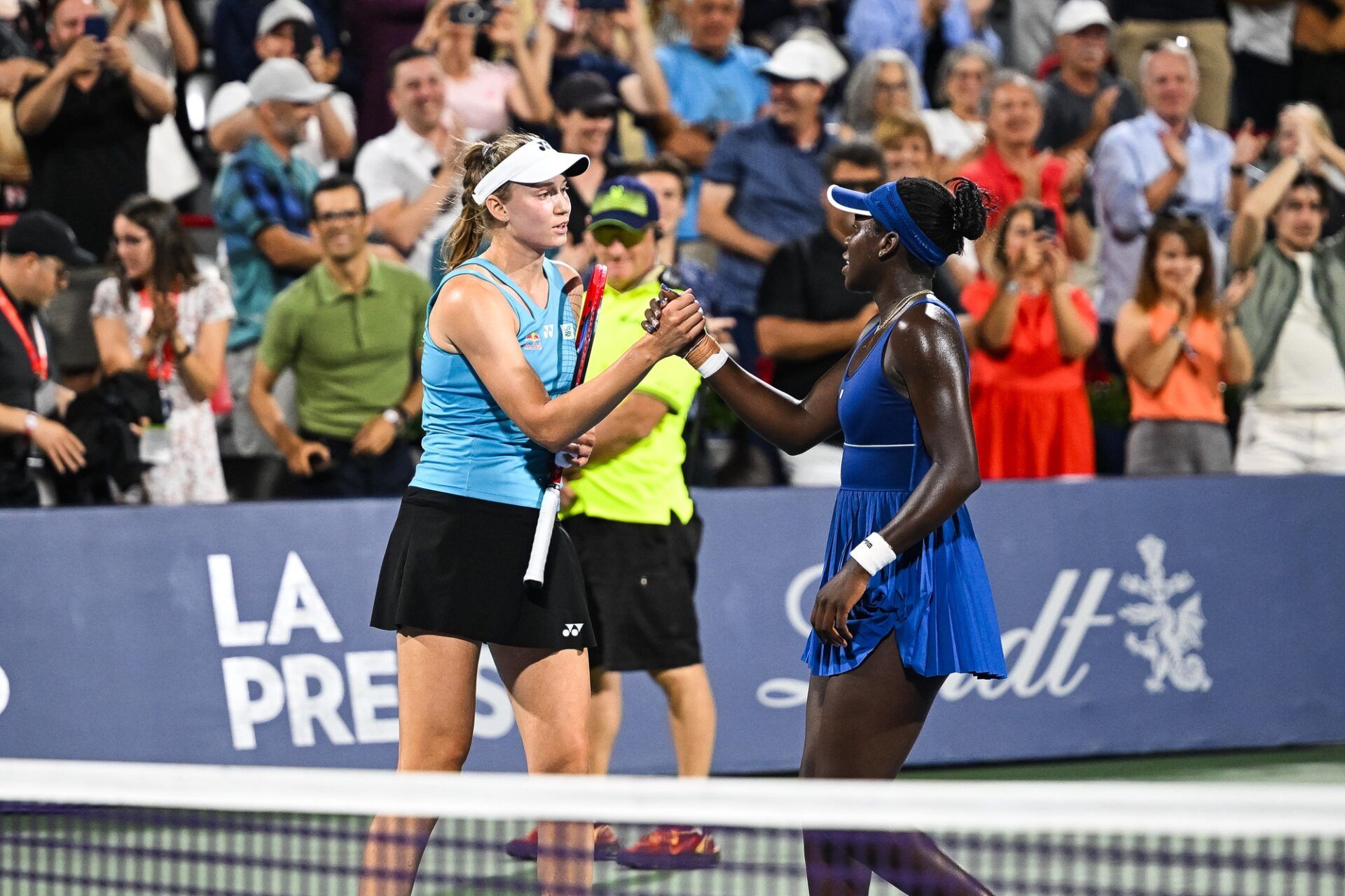 Elena Rybakina (KAZ) congratulates semifinal winner Victoria Mboko (CAN) after the end of the match at IGA Stadium.