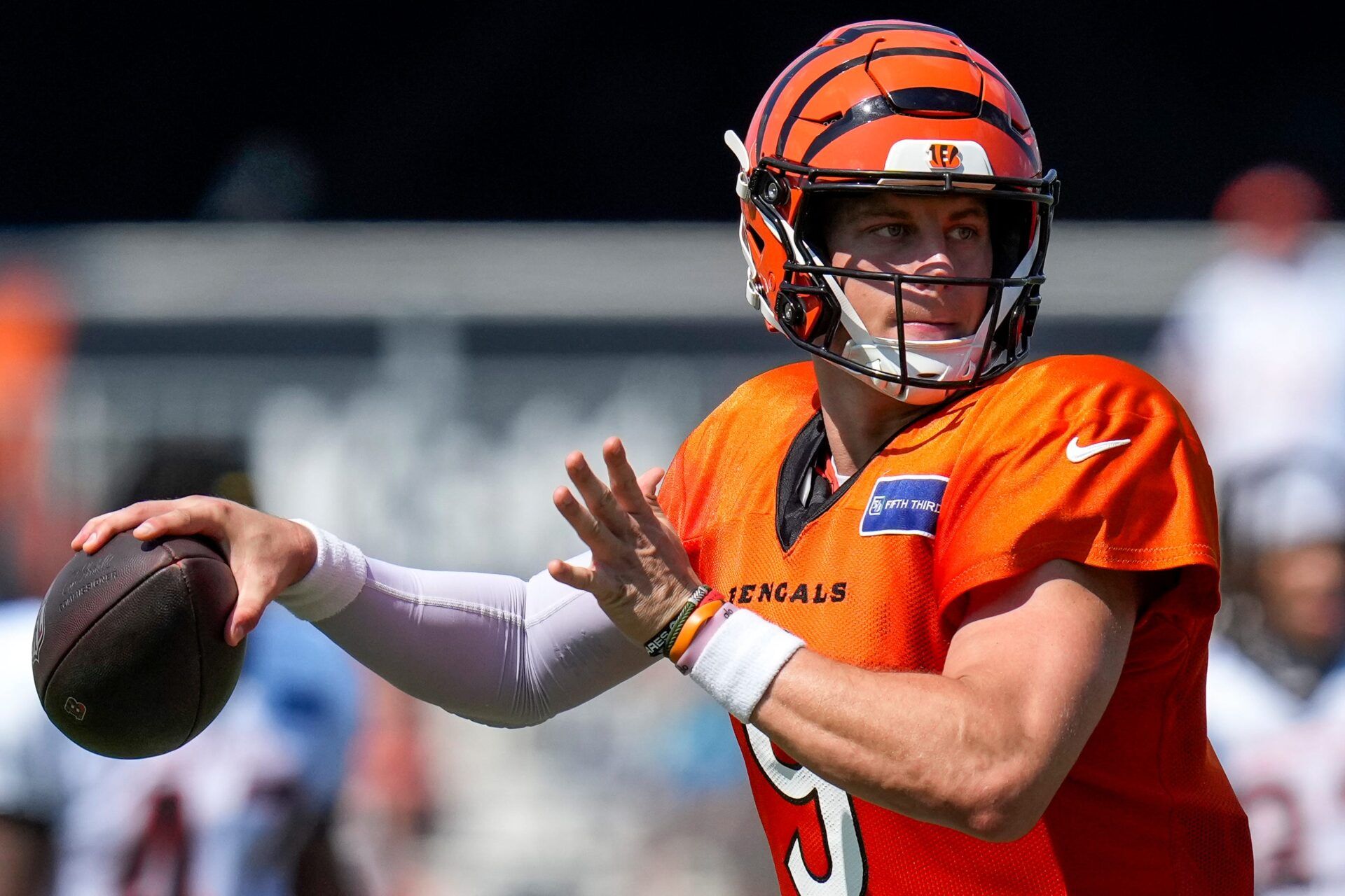 Cincinnati Bengals quarterback Joe Burrow (9) throws a pass during a preseason training camp practice in downtown Cincinnati on Wednesday, July 30, 2025.