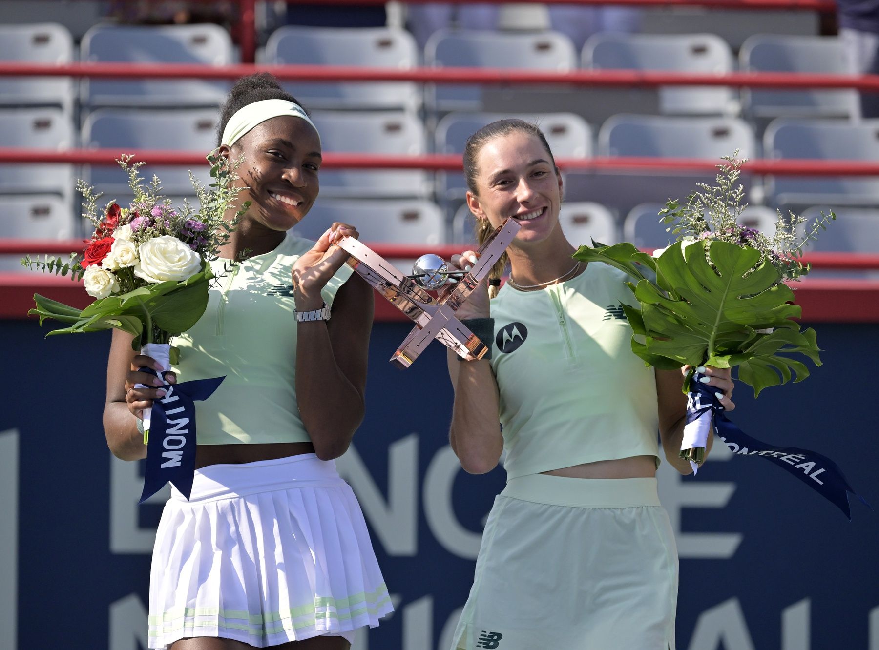 Coco Gauff (USA) and McCartney Kessler (USA) pose with the championship trophy after the doubles final at IGA Stadium.