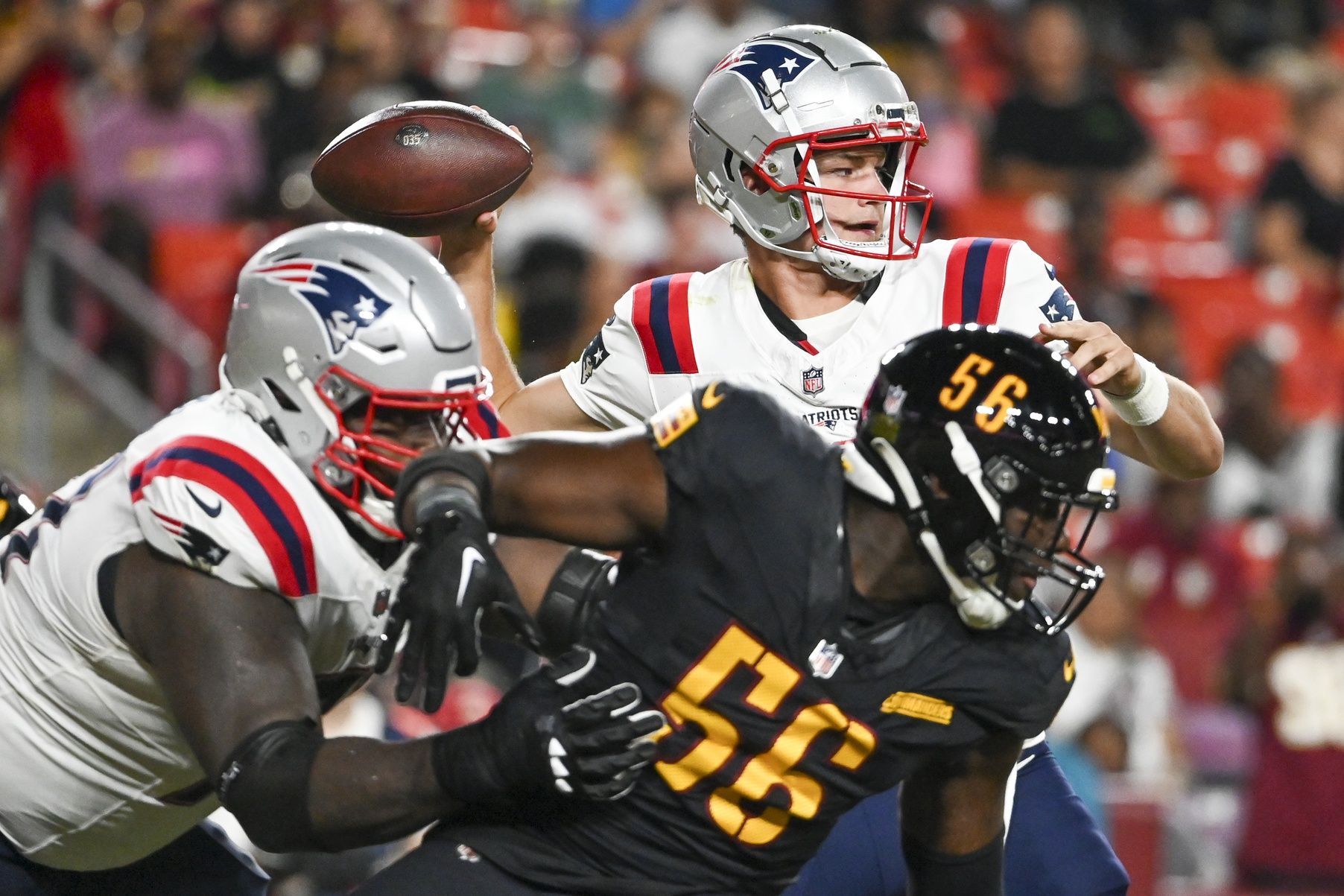New England Patriots quarterback Drake Maye (10) throws fro the pocket during the first half against the Washington Commanders at Commanders Field.