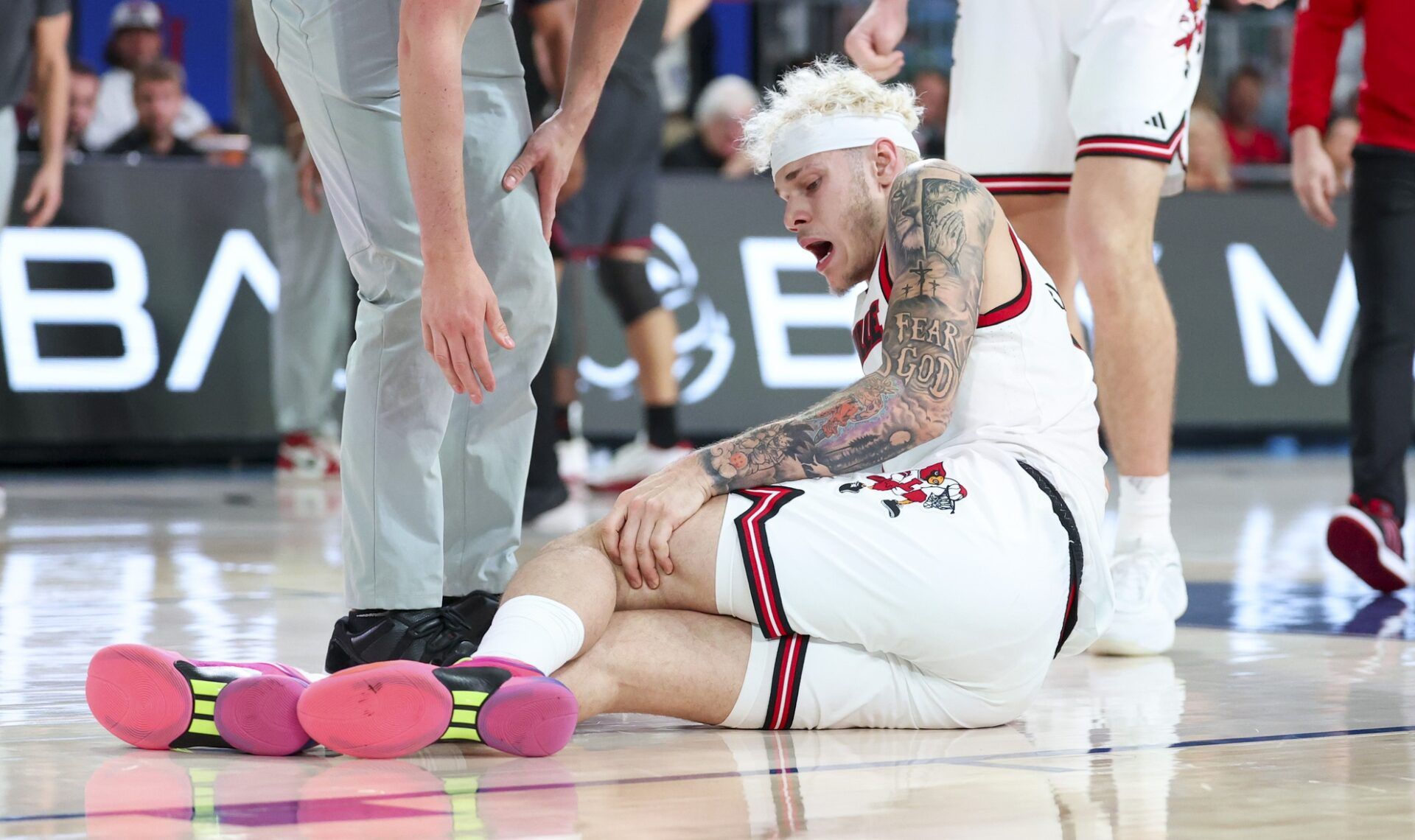 Louisville Cardinals forward Kasean Pryor (7) injures his leg against the Oklahoma Sooners during the second half at Imperial Arena at the Atlantis resort.