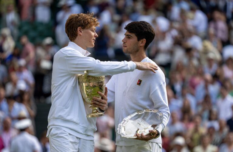 Carlos Alcaraz of Spain and Jannik Sinner of Italy pose with their trophies after the menÕs singles final on day 14 at All England Lawn Tennis and Croquet Club.