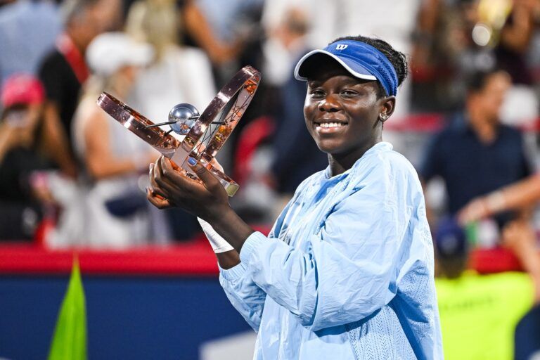 Victoria Mboko (CAN) tournament winner against Naomi Osaka (JPN) holds her trophy at IGA Stadium.