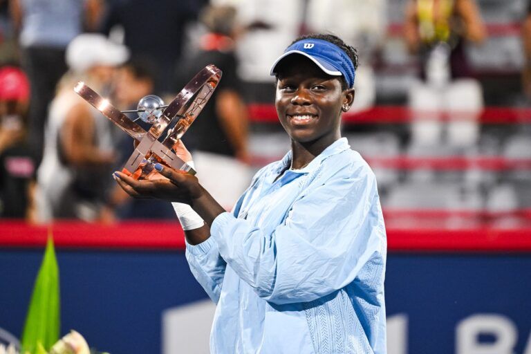 Victoria Mboko (CAN) tournament winner against Naomi Osaka (JPN) holds her trophy at IGA Stadium.