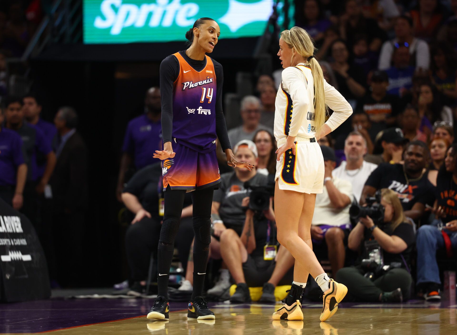 Indiana Fever guard Sophie Cunningham (8) reacts alongside Phoenix Mercury forward DeWanna Bonner (14) in the first half of a WNBA game at PHX Arena.