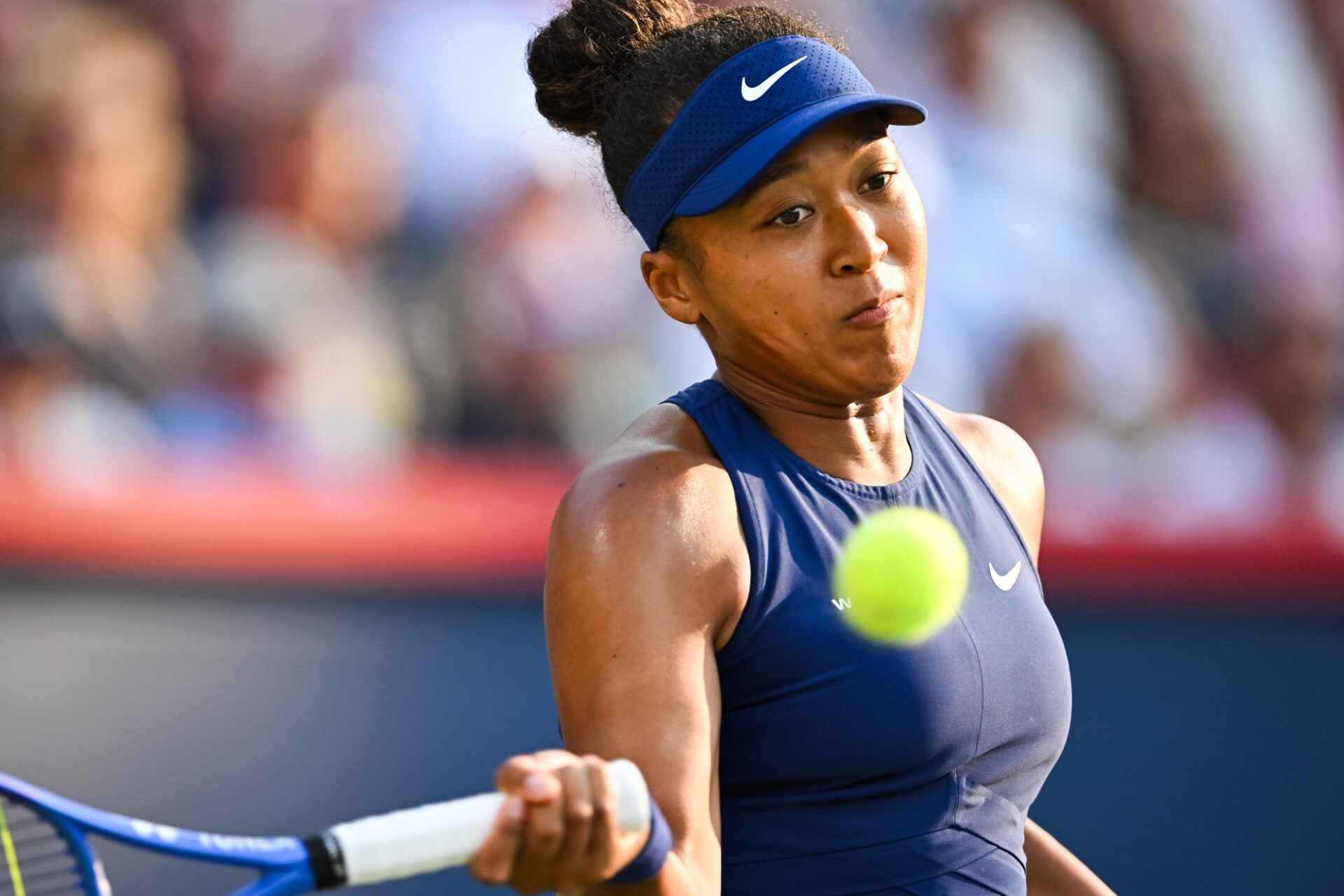 Naomi Osaka (JPN) returns the ball to Victoria Mboko (CAN) during singles final play at IGA Stadium.