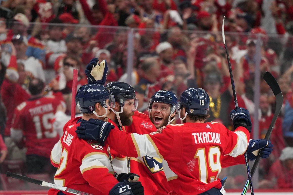 Florida Panthers defenseman Aaron Ekblad (5) celebrates scoring an empty net goal with defenseman Gustav Forsling (42) and forward Matthew Tkachuk (19) during the third period against the Edmonton Oilers in game two of the 2024 Stanley Cup Final at Amerant Bank Arena.