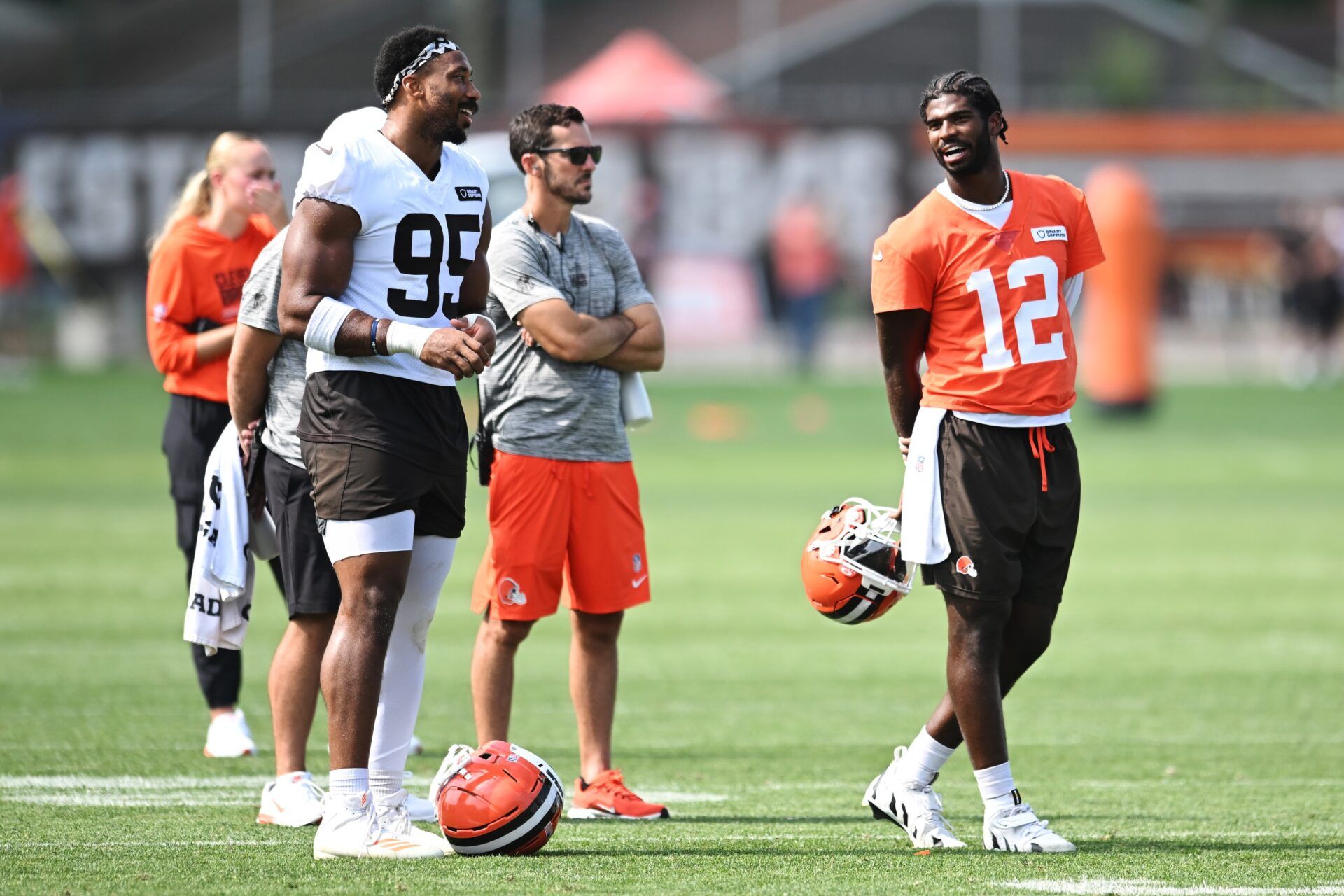 Cleveland Browns defensive end Myles Garrett (95) talks to quarterback Shedeur Sanders (12) during training camp at CrossCountry Mortgage Campus.