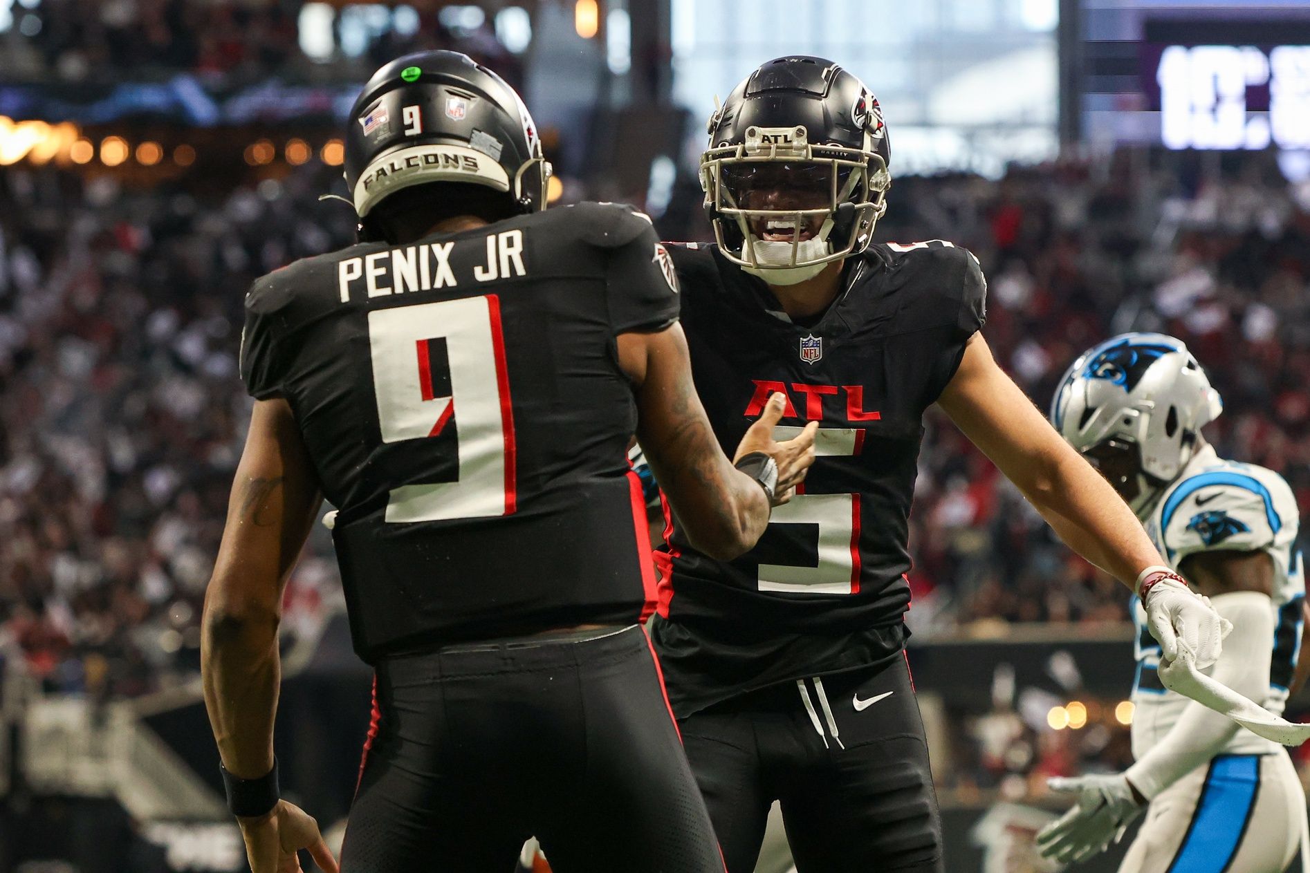 Atlanta Falcons quarterback Michael Penix Jr. (9) celebrates with wide receiver Drake London (5) after a touchdown run against the Carolina Panthers in the second quarter at Mercedes-Benz Stadium.
