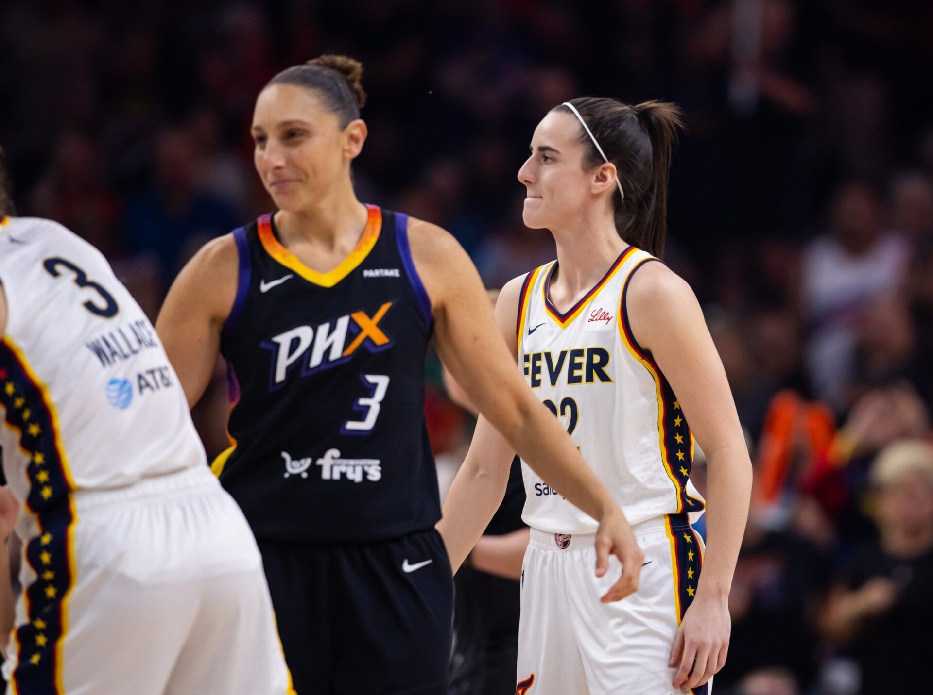 Indiana Fever guard Caitlin Clark (22) against Phoenix Mercury guard Diana Taurasi (3) during a WNBA game at Footprint Center.