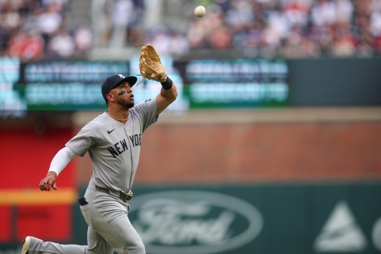 New York Yankees third baseman Oswald Peraza (18) catches a pop fly against the Atlanta Braves in the first inning at Truist Park.