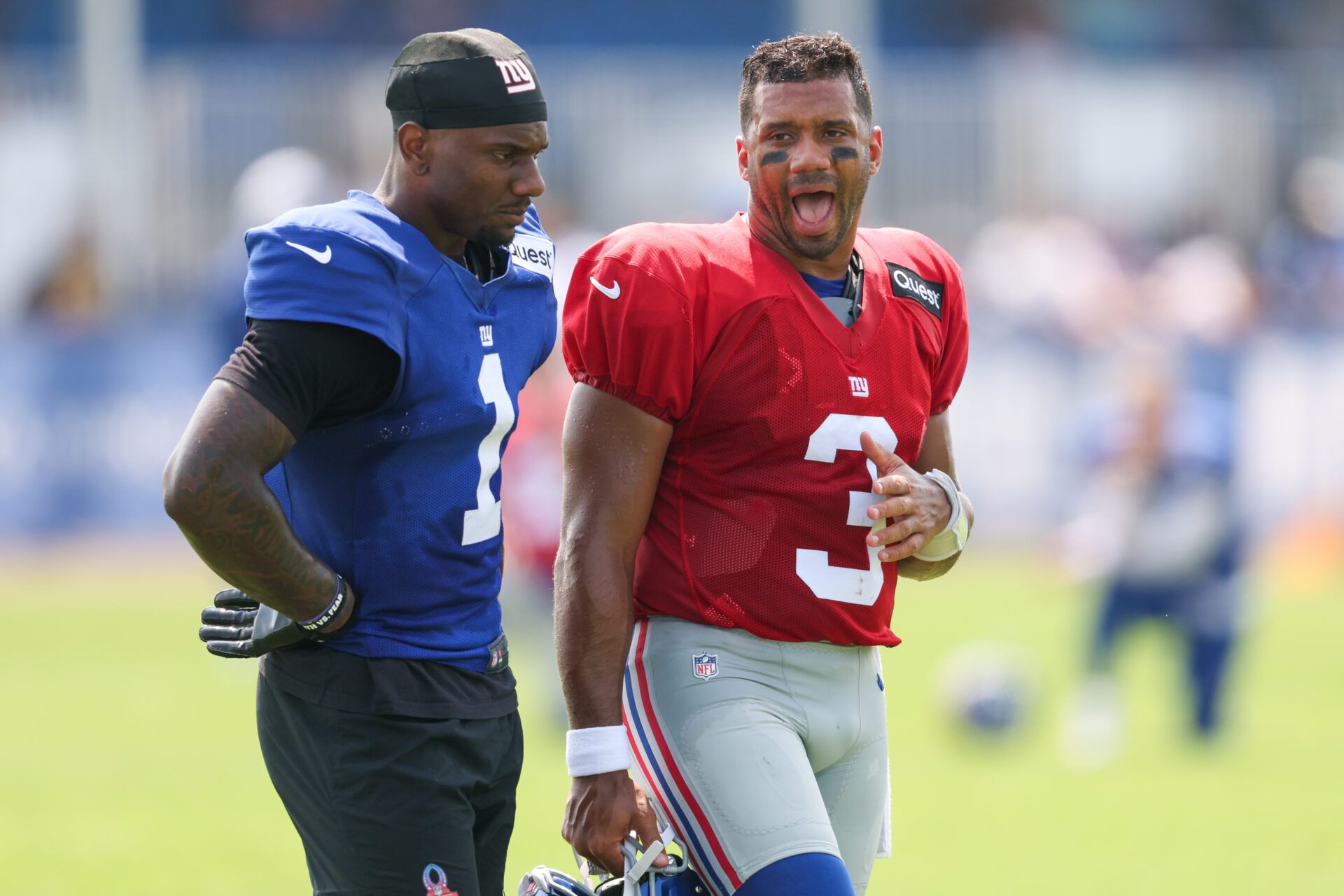 New York Giants wide receiver Malik Nabers (1) talks with quarterback Russell Wilson (3) during training camp at Quest Diagnostics Training Center.