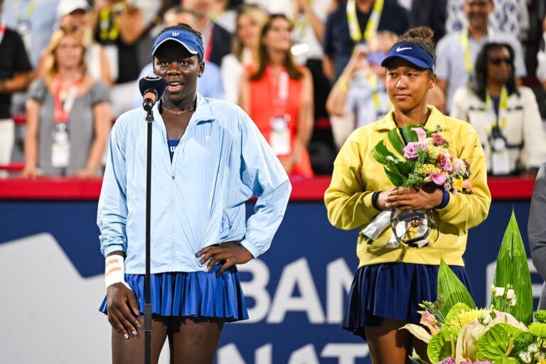 Victoria Mboko (CAN) tournament winner addresses the crowd beside runner up Naomi Osaka (JPN) at IGA Stadium.