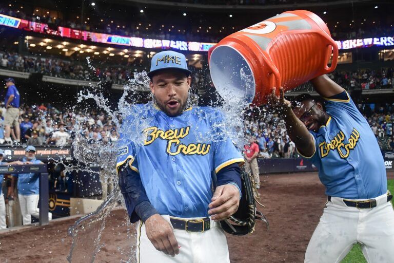Milwaukee Brewers center fielder Blake Perkins (16) is dunked by shortstop Andruw Monasterio (14) after the Brewers beat the New York Mets at American Family Field.