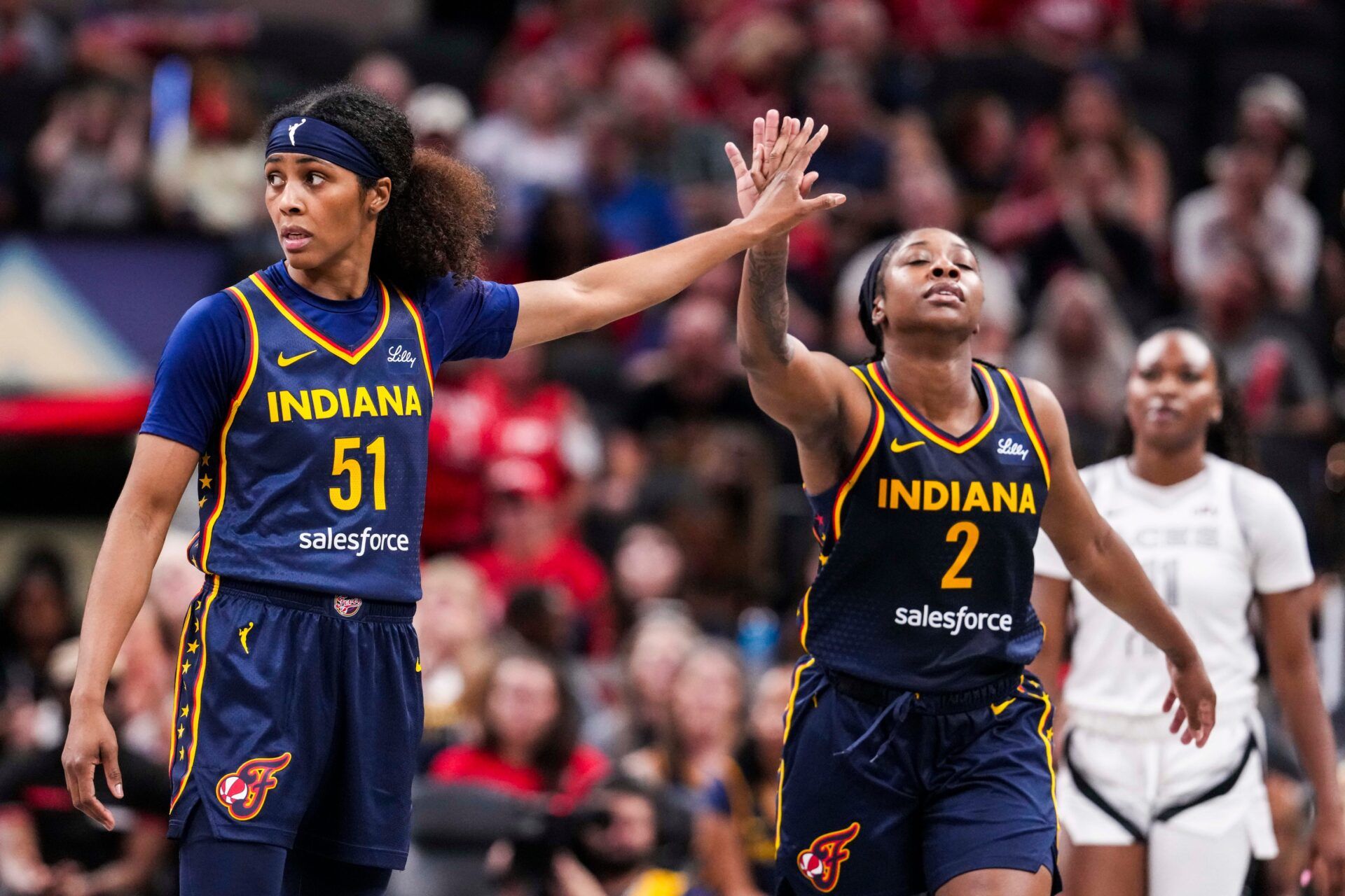 Indiana Fever guard Sydney Colson (51) high-fives Indiana Fever guard Aari McDonald (2) Thursday, July 3, 2025, during a game between the Indiana Fever and the Las Vegas Aces at Gainbridge Fieldhouse in Indianapolis. The Indiana Fever defeated the Las Vegas Aces, 81-54.