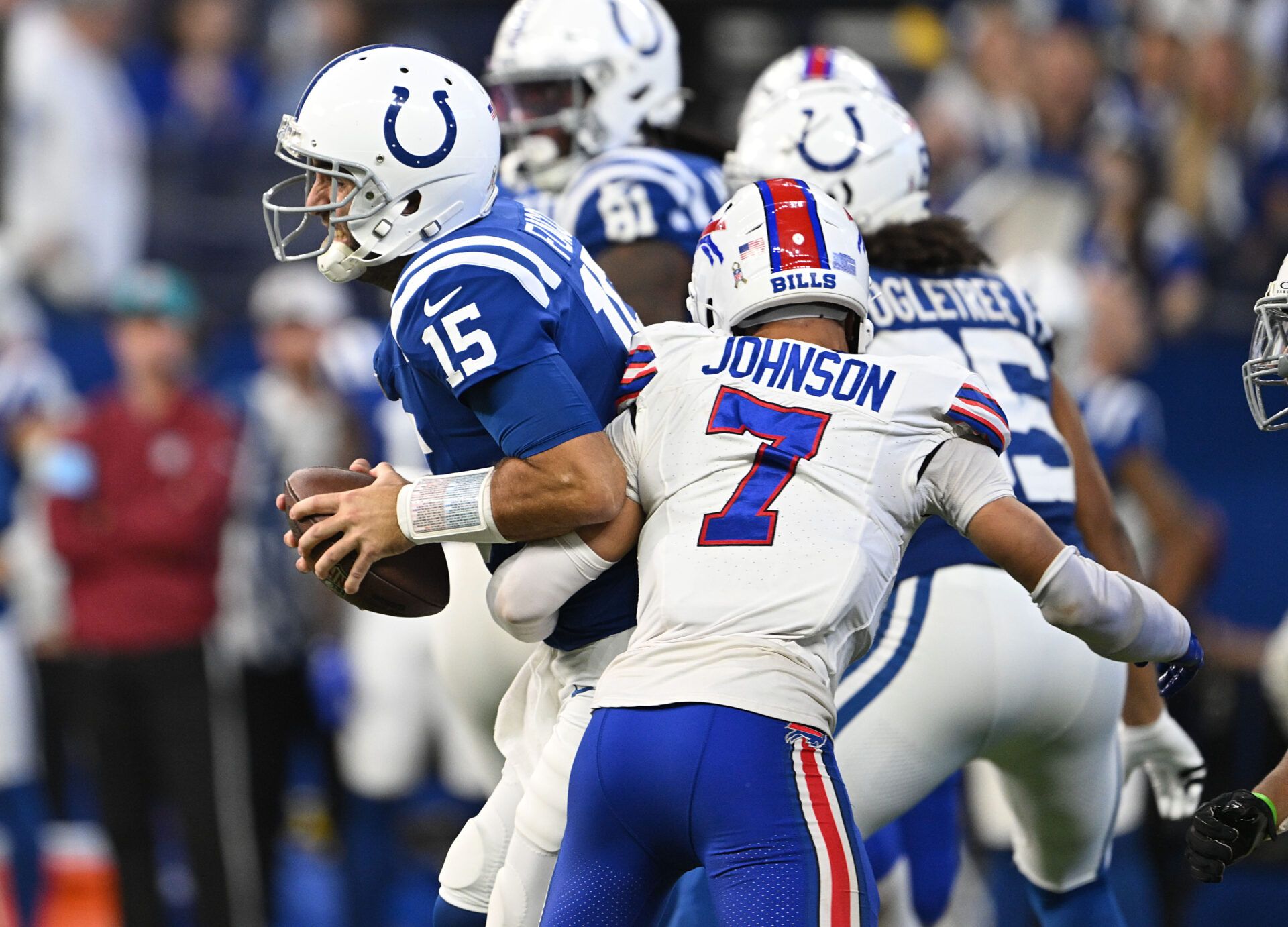 Indianapolis Colts quarterback Joe Flacco (15) is sacked by Buffalo Bills cornerback Taron Johnson (7) during the second half at Lucas Oil Stadium.
