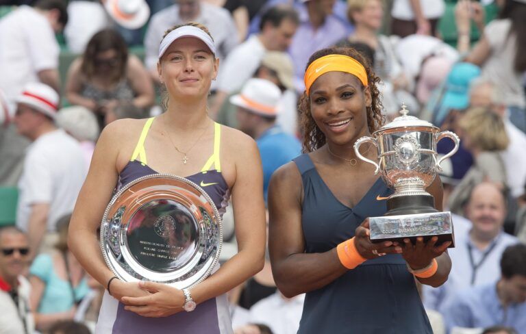 Serena Williams (USA), right, and Maria Sharapova (RUS) pose with their trophies after their match on day 14 of the 2013 French Open at Roland Garros.