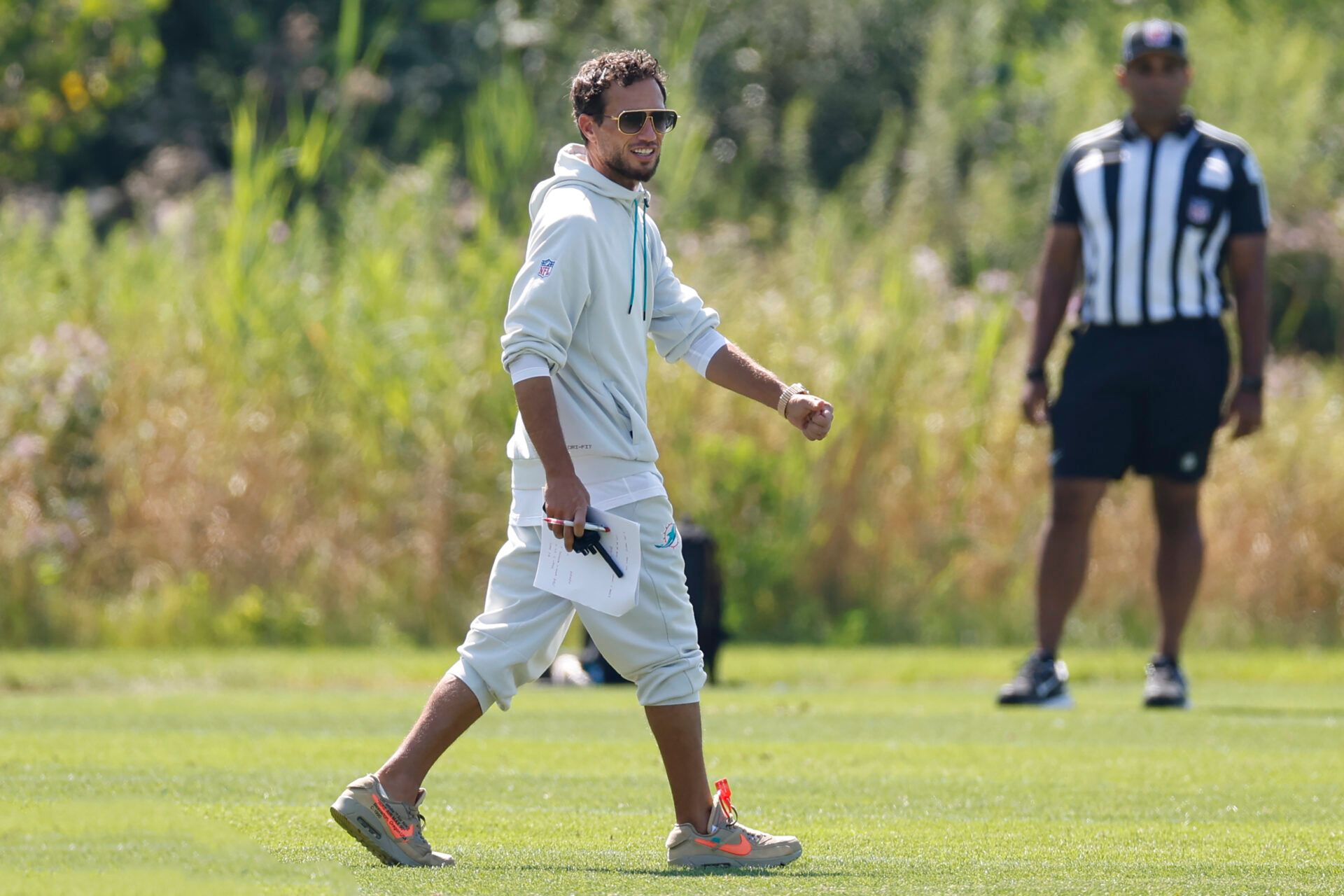 Miami Dolphins head coach Mike McDaniel walks on the field during joint training camp practice with the Chicago Bears ahead of Sunday's preseason opener.