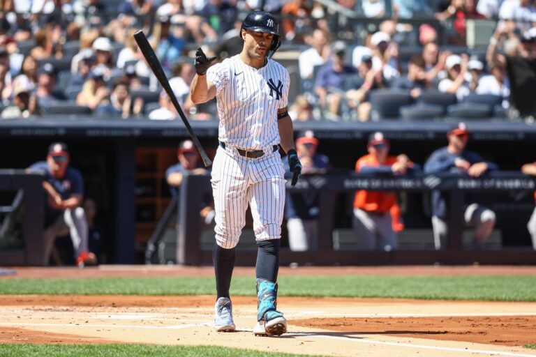 New York Yankees right fielder Giancarlo Stanton (27) flips his bat after walking with the bases loaded in the first inning against the Houston Astros at Yankee Stadium.