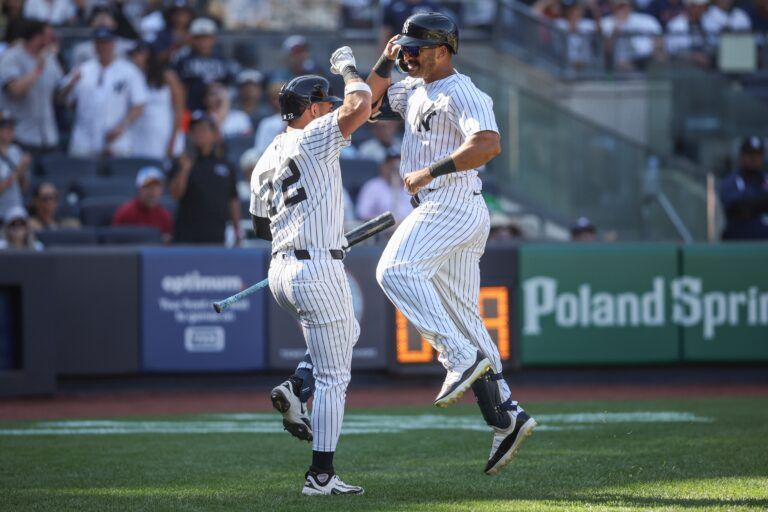 New York Yankees center fielder Trent Grisham (12) is greeted by second baseman José Caballero (72) after hitting a solo home run in the eighth inning against the Houston Astros at Yankee Stadium.