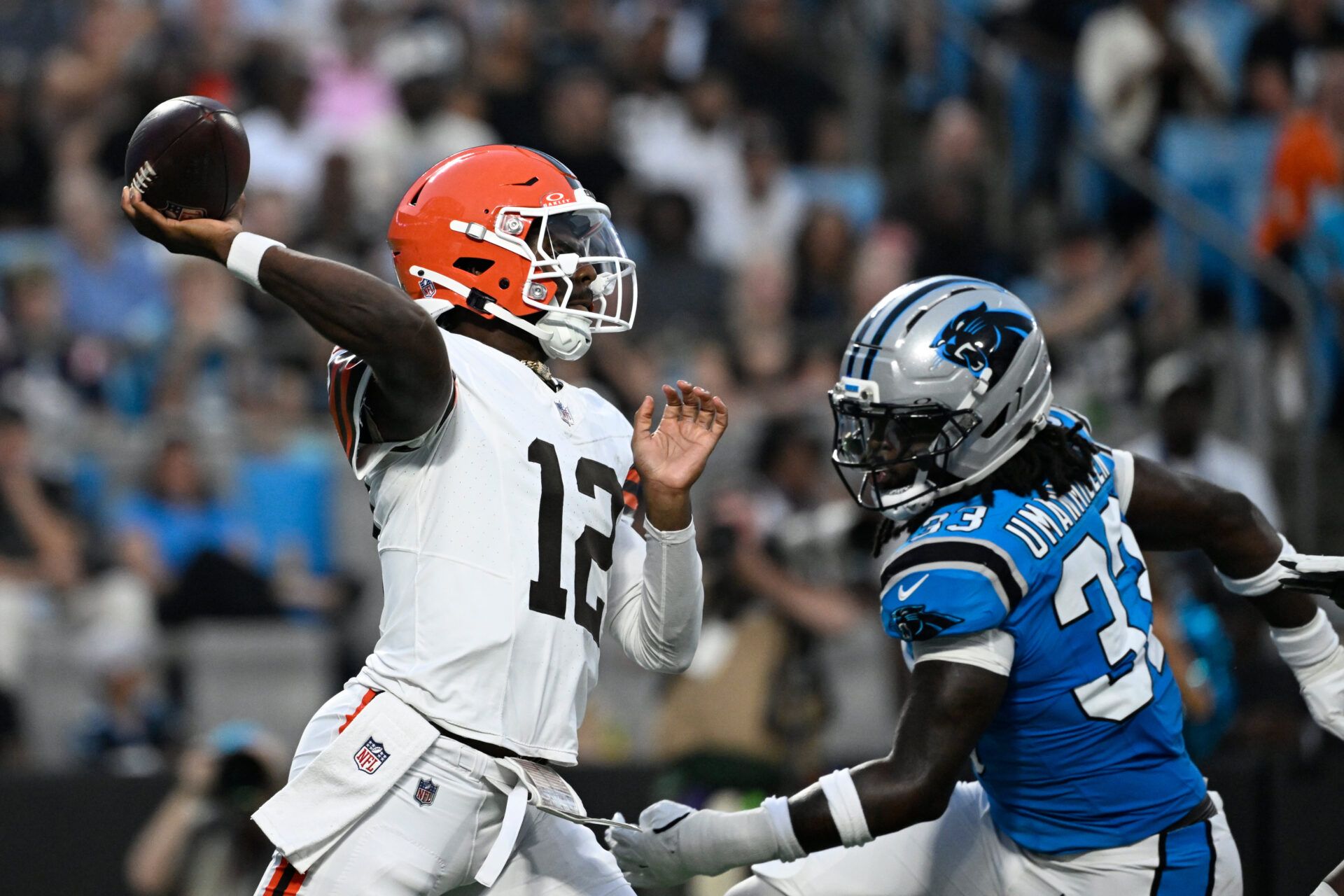 Cleveland Browns quarterback Shedeur Sanders (12) passes the ball as Carolina Panthers linebacker Princely Umanmielen (33) pressures in the second quarter at Bank of America Stadium.