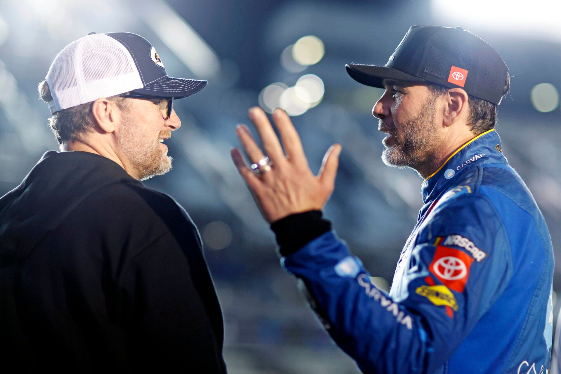 NASCAR team owner Dale Earnhardt Jr. talks with NASCAR Cup Series driver Jimmie Johnson (84) during qualifying for the Daytona 500 at Daytona International Speedway.