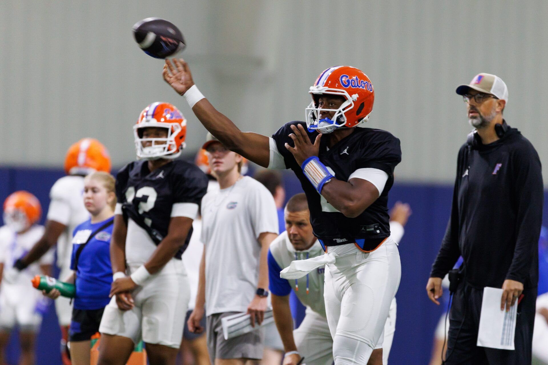 Florida Gators quarterback DJ Lagway (2) throws the ball while Florida Gators assistant coach for quarterbacks Ryan O'Hara looks on during fall football practice at Sanders Indoor Practice Fields at the University of Florida in Gainesville, FL on Thursday, August 7, 2025. [Matt Pendleton/Gainesville Sun]