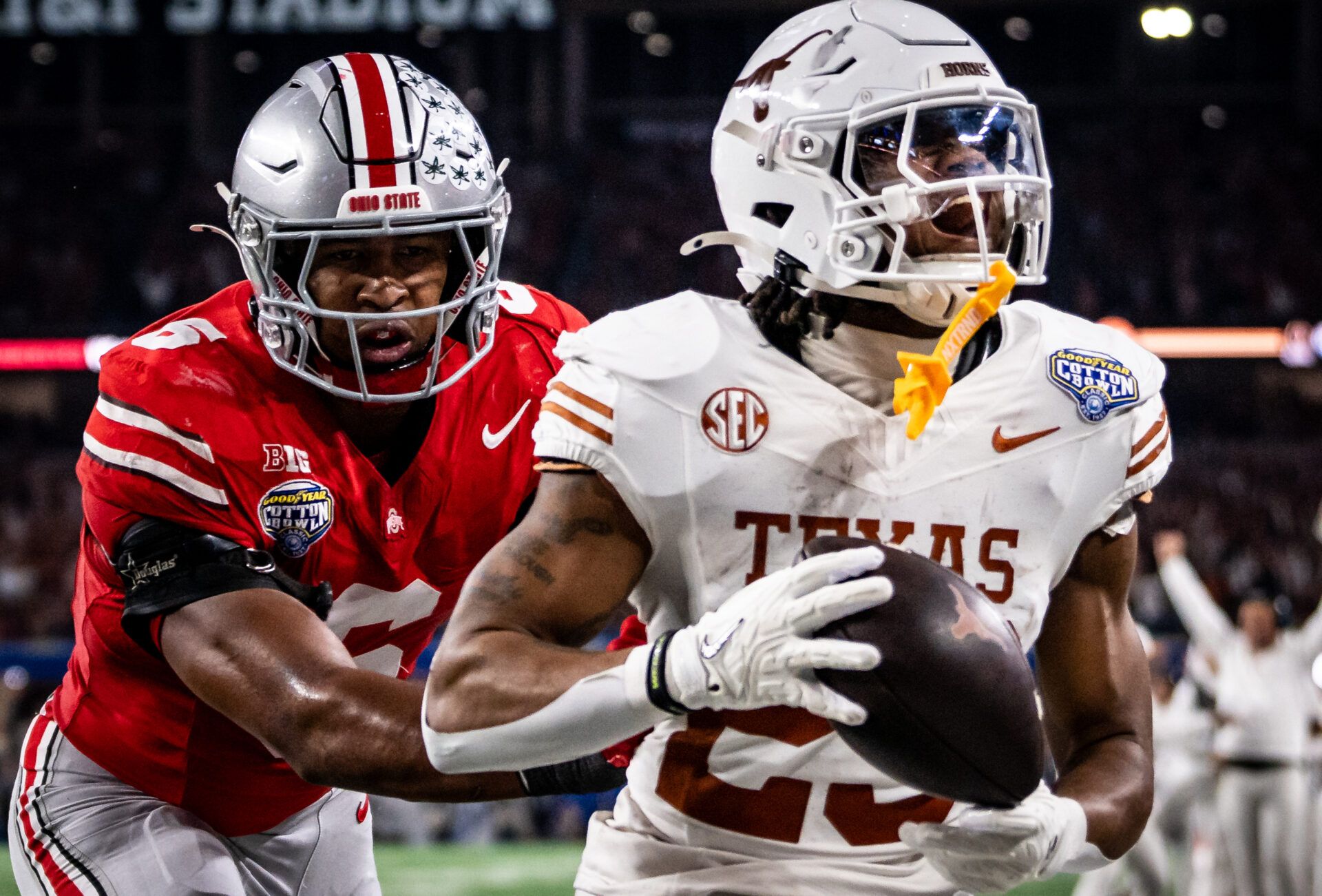 Texas Longhorns running back Jaydon Blue (23) runs into the end zone to score after catching a pass from quarterback Quinn Ewers (3) while Ohio State Buckeyes safety Sonny Styles (6) runs to defend late in the second quarter as the Texas Longhorns play the Ohio State Buckeyes in the Cotton Bowl College Football Playoff semi-final at AT&T Stadium.