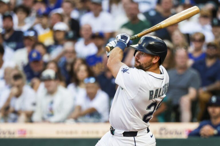 Seattle Mariners catcher Cal Raleigh (29) hits a three-run home run against the Tampa Bay Rays during the third inning at T-Mobile Park.