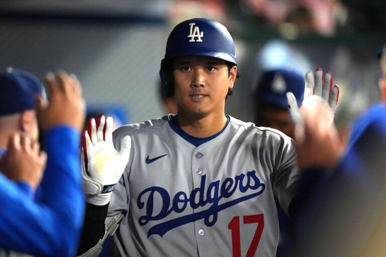 Los Angeles Dodgers designated hitter Shohei Ohtani (17) celebrates with teammates after hitting a home run in the eighth inning against the Los Angeles Angels at Angel Stadium.