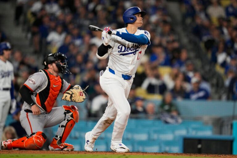 Los Angeles Dodgers designated hitter Shohei Ohtani hits a home run during the seventh inning of a baseball game against the San Francisco Giants in Los Angeles, Wednesday, April 3, 2024. (AP Photo/Ashley Landis)