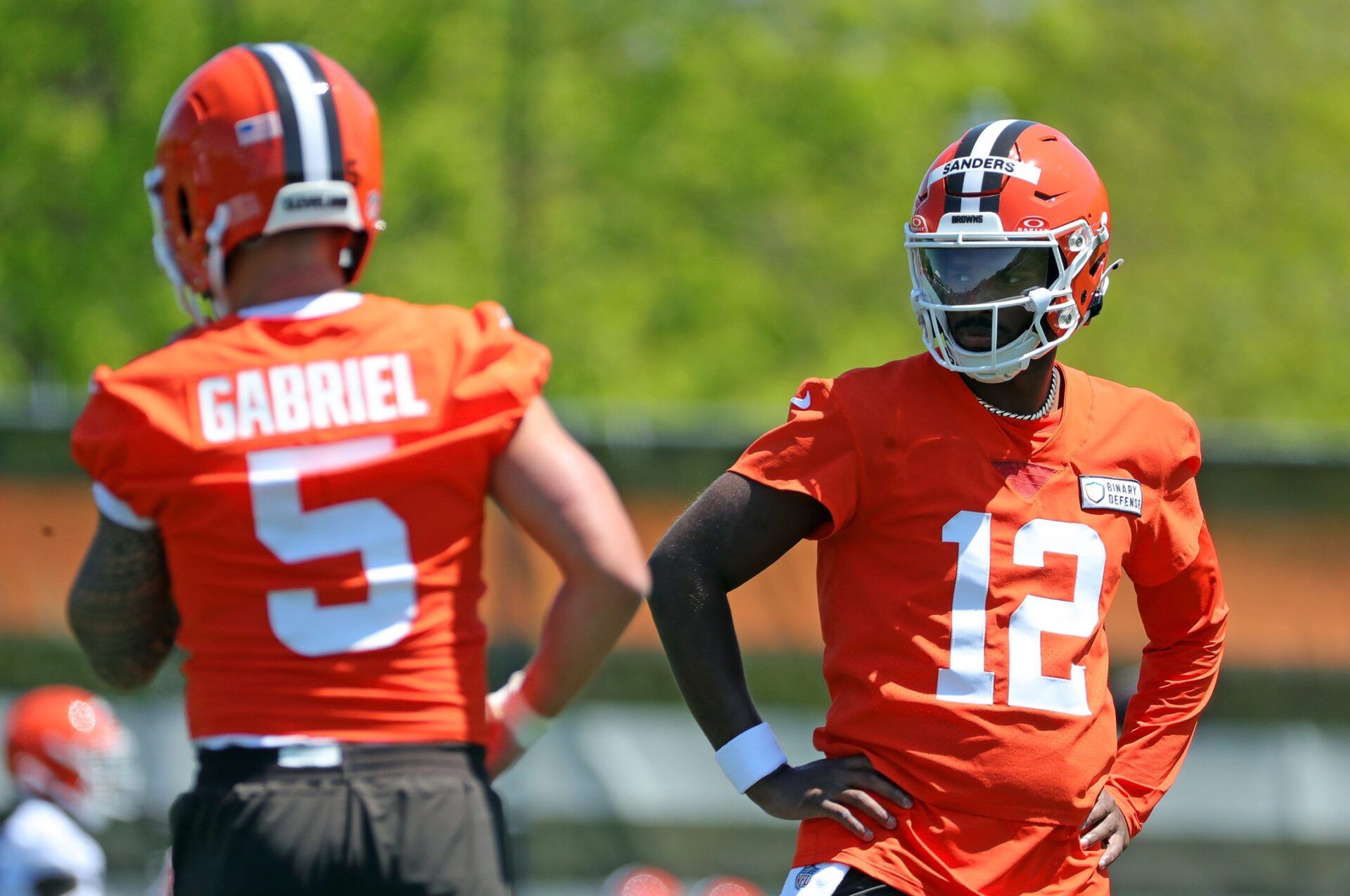 Cleveland Browns quarterback Shedeur Sanders (12) watches quarterback Dillon Gabriel (5) during day two of NFL rookie minicamp at the Cleveland Browns training facility on Saturday, May 10, 2025, in Berea, Ohio. IMAGN