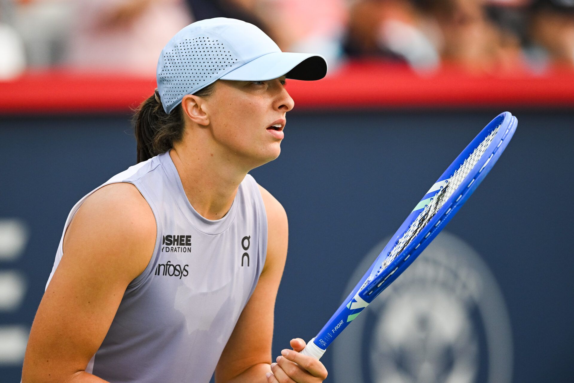Iga Swiatek (POL) waits for Clara Tauson (DEN) to serve the ball in fourth round play at IGA Stadium.