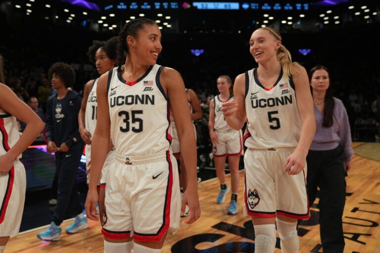 Connecticut Huskies guard Azzi Fudd (35) and Connecticut Huskies guard Paige Bueckers (5) celebrate after the game against the Louisville Cardinals at Barclays Center.