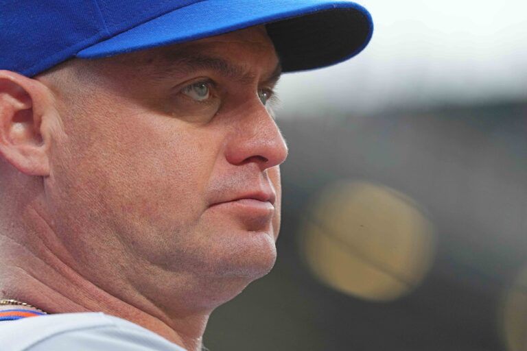 New York Mets manager Carlos Mendoza (64) watches from the dugout during the first inning against the Baltimore Orioles at Oriole Park at Camden Yards.