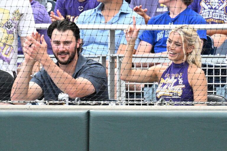 LSU Tiger alumni Paul Skenes and Livvy Dunne watch action against the UCLA Bruinsat Charles Schwab Field.