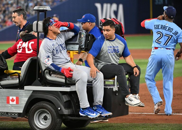 Chicago Cubs catcher Miguel Amaya (9) is taken from the game on a cart after injuring his ankle at first base in the eighth inning against the Toronto Blue Jays at Rogers Centre.