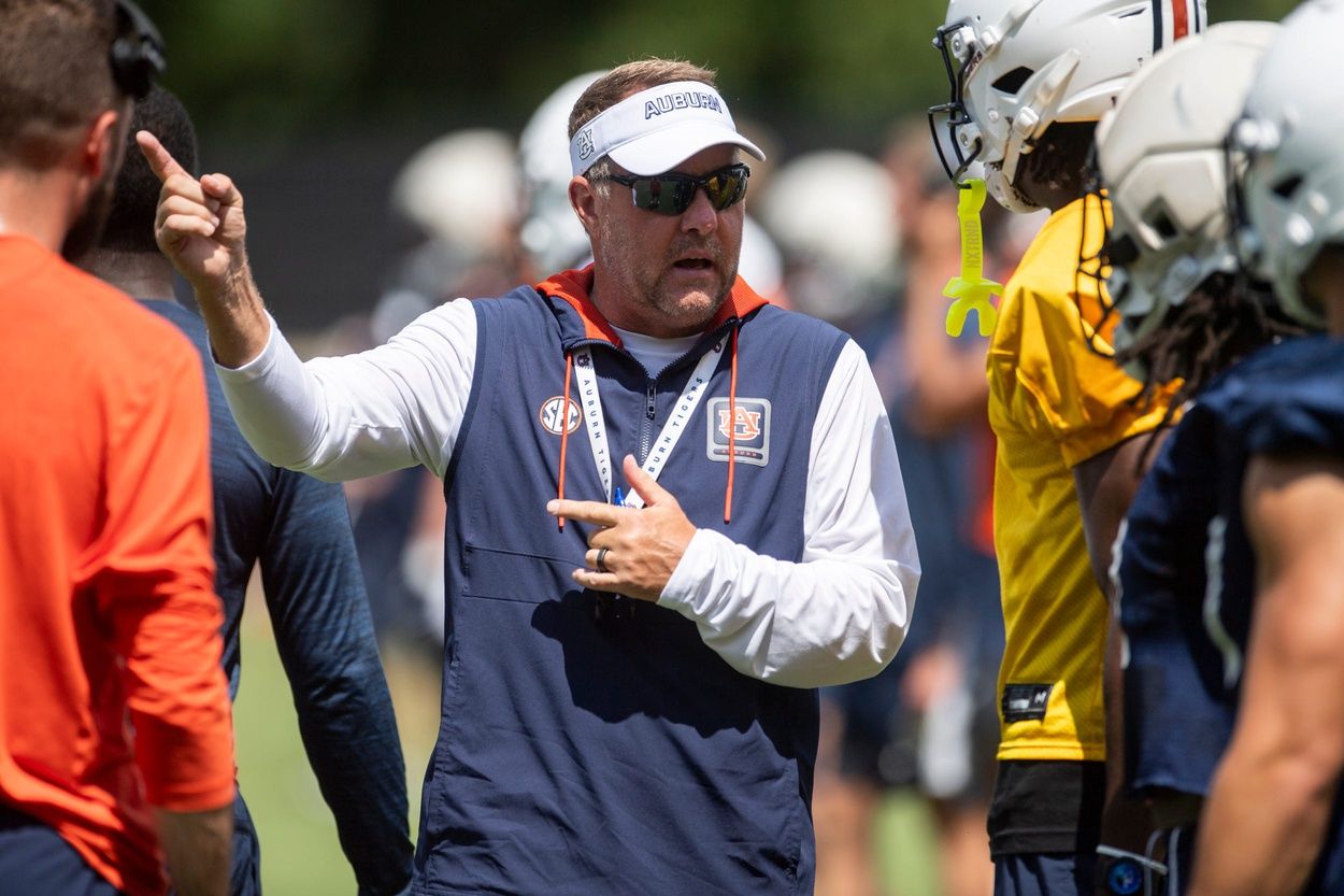 Auburn Tigers head coach Hugh Freeze talks with wide receiver Cam Coleman (8) during practice at Woltosz Football Performance Center in Auburn, Ala. on Thursday, Aug. 14, 2025.