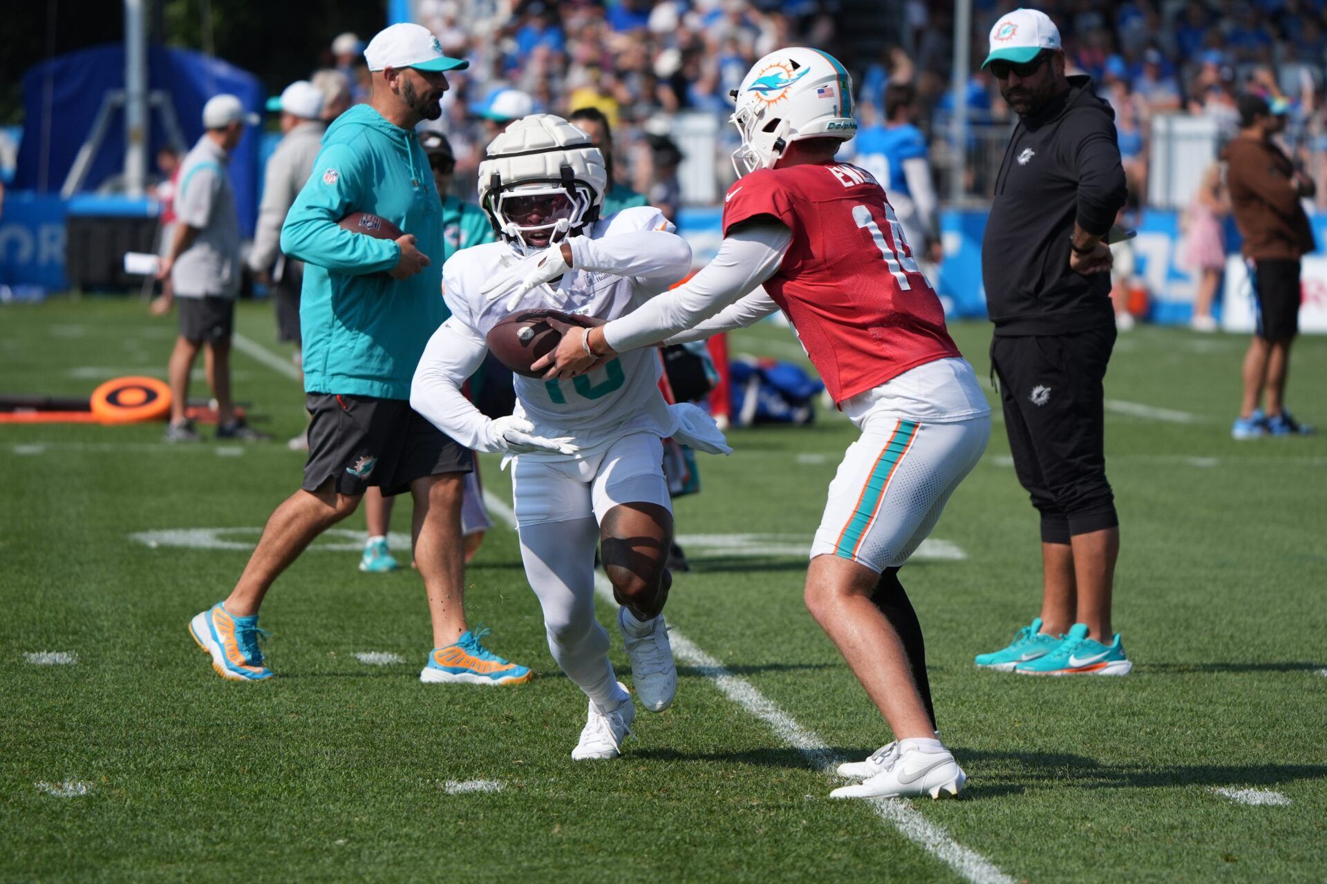 Miami Dolphins QB Quinn Ewers (14) hands the ball off to RB Mike Boone (16), during joint practice with the Detroit Lions at the Lions headquarters and training facility in Allen Park, Thursday, Aug. 14 2025