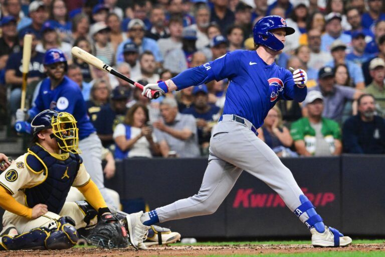Chicago Cubs center fielder Pete Crow-Armstrong (4) hits a double to drive in a run in the third inning as Milwaukee Brewers catcher William Contreras (24) looks on at American Family Field.