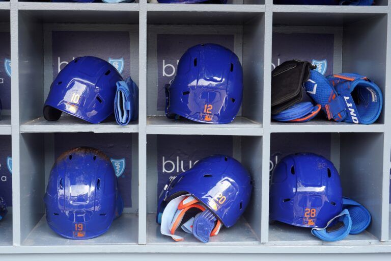 The batting helmets of New York Mets third baseman Eduardo Escobar (10) and shortstop Francisco Lindor (12) and left fielder Mark Canha (19) and first baseman Pete Alonso (20) and left fielder J.D. Davis (28) are seem in the dugout at Dodger Stadium before a game against the Los Angeles Dodgers.