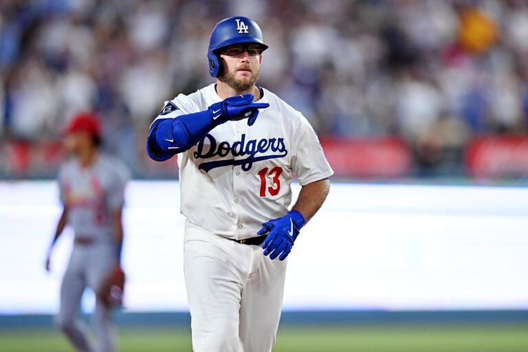 Los Angeles Dodgers third baseman Max Muncy (13) hits a two run home run during the third inning against the St. Louis Cardinals at Dodger Stadium.