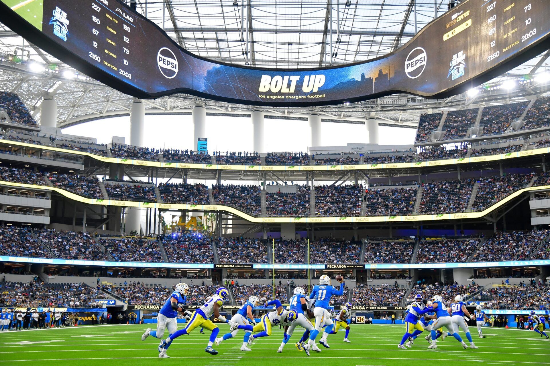 Los Angeles Chargers quarterback Luis Perez (11) moves out to pass against the Los Angeles Rams during the second half at SoFi Stadium.