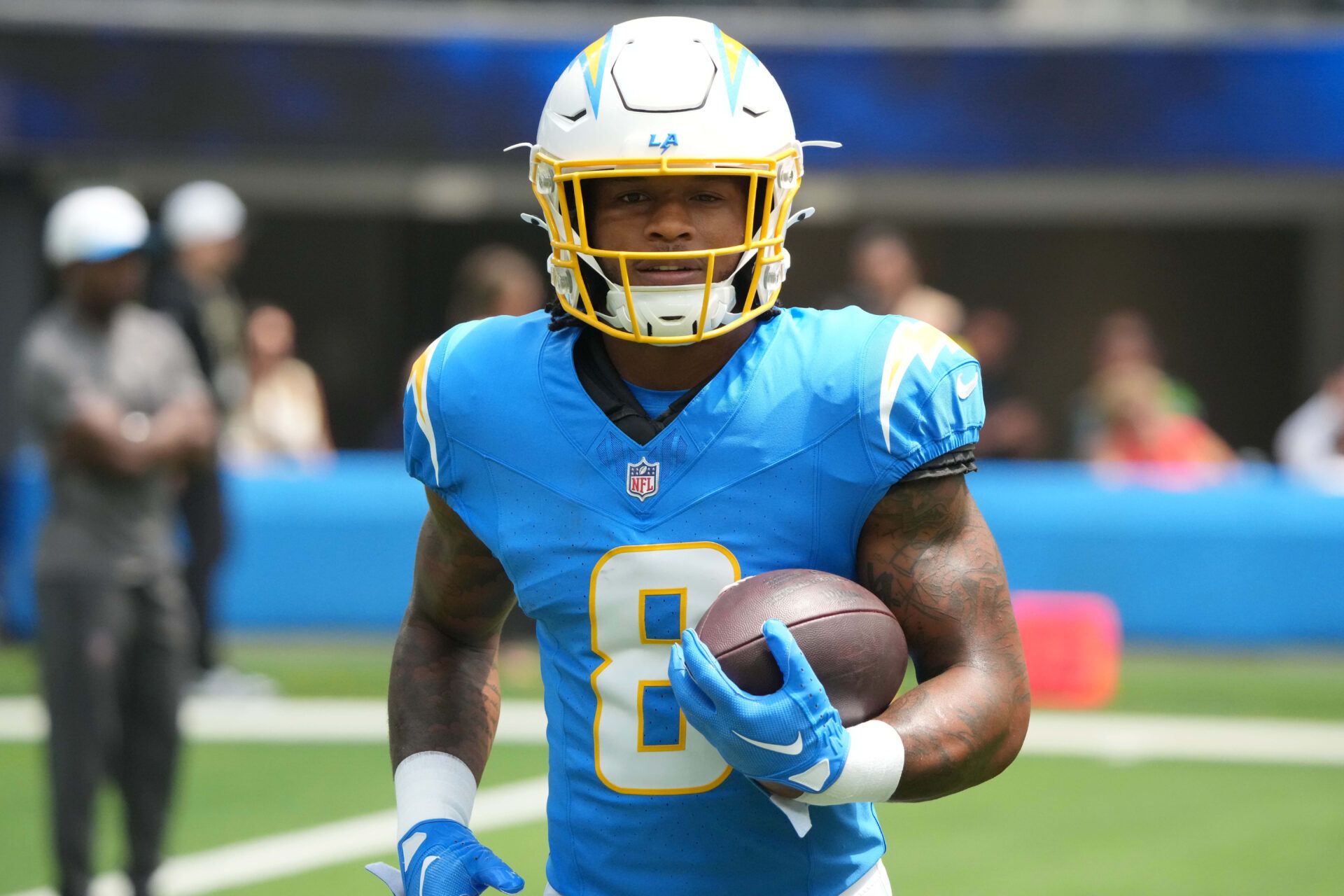 Los Angeles Chargers running back Omarion Hampton (8) carries the ball before the game against the New Orleans Saints at SoFi Stadium.