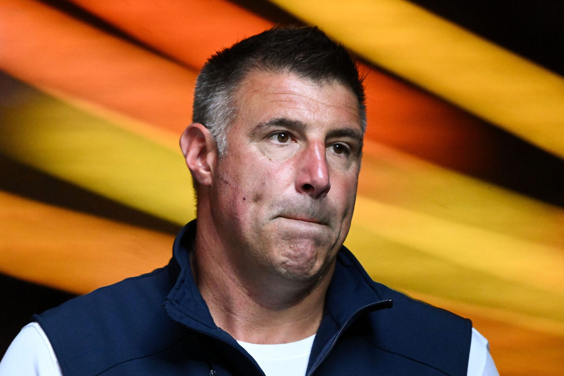 New England Patriots head coach Mike Vrabel walks onto the field before a game against the Washington Commanders at Gillette Stadium.