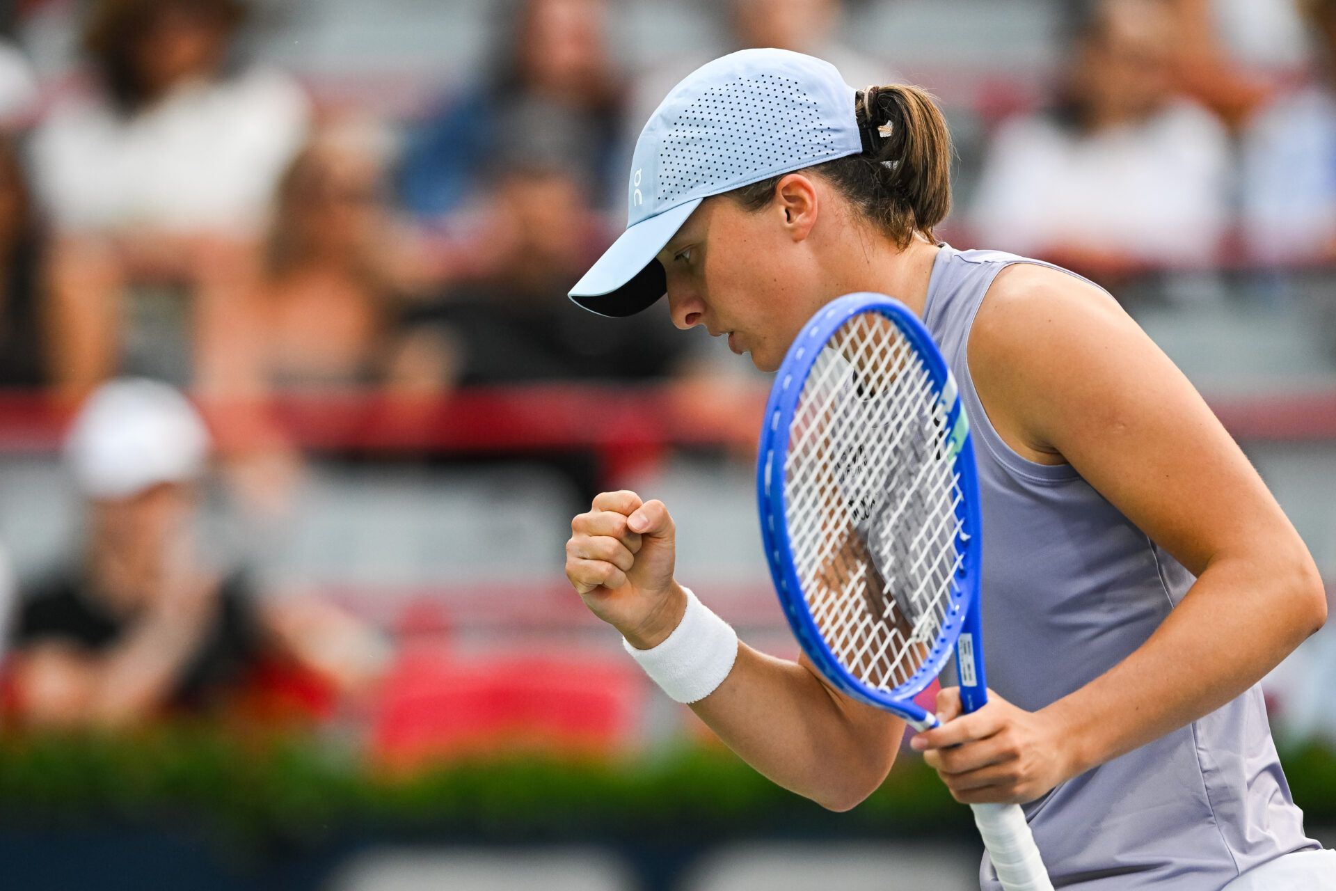 Iga Swiatek (POL) reacts after winning a point against Clara Tauson (DEN) in fourth round play at IGA Stadium.