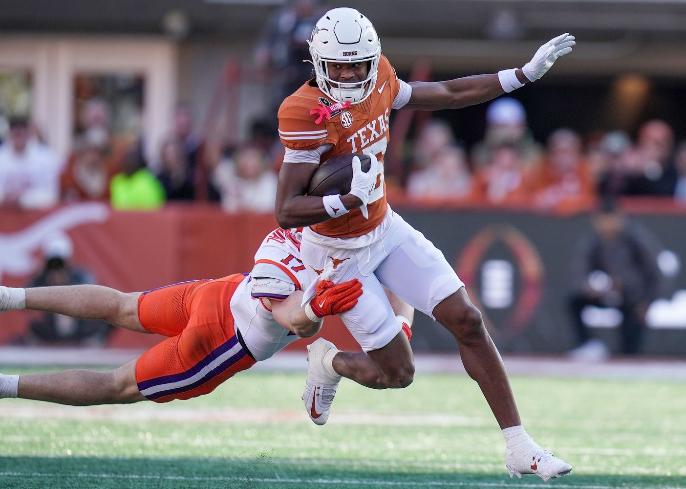 TTexas Longhorns wide receiver Ryan Wingo (5) runs for yardage against Clemson Tigers linebacker Wade Woodaz (17) in the first half of a first round College Football Playoffs game at Darrell K Royal-Texas Memorial Stadium.