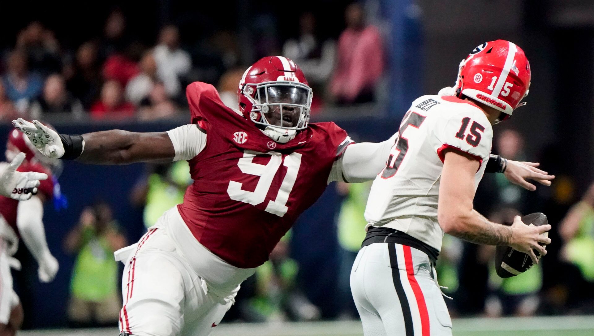 Alabama Crimson Tide defensive lineman Jeheim Oatis (91) sacks Georgia Bulldogs quarterback Carson Beck (15) for a loss but was called for a face mask penalty at Mercedes-Benz Stadium. Alabama defeated Georgia 27-24 to claim the SEC Championship.