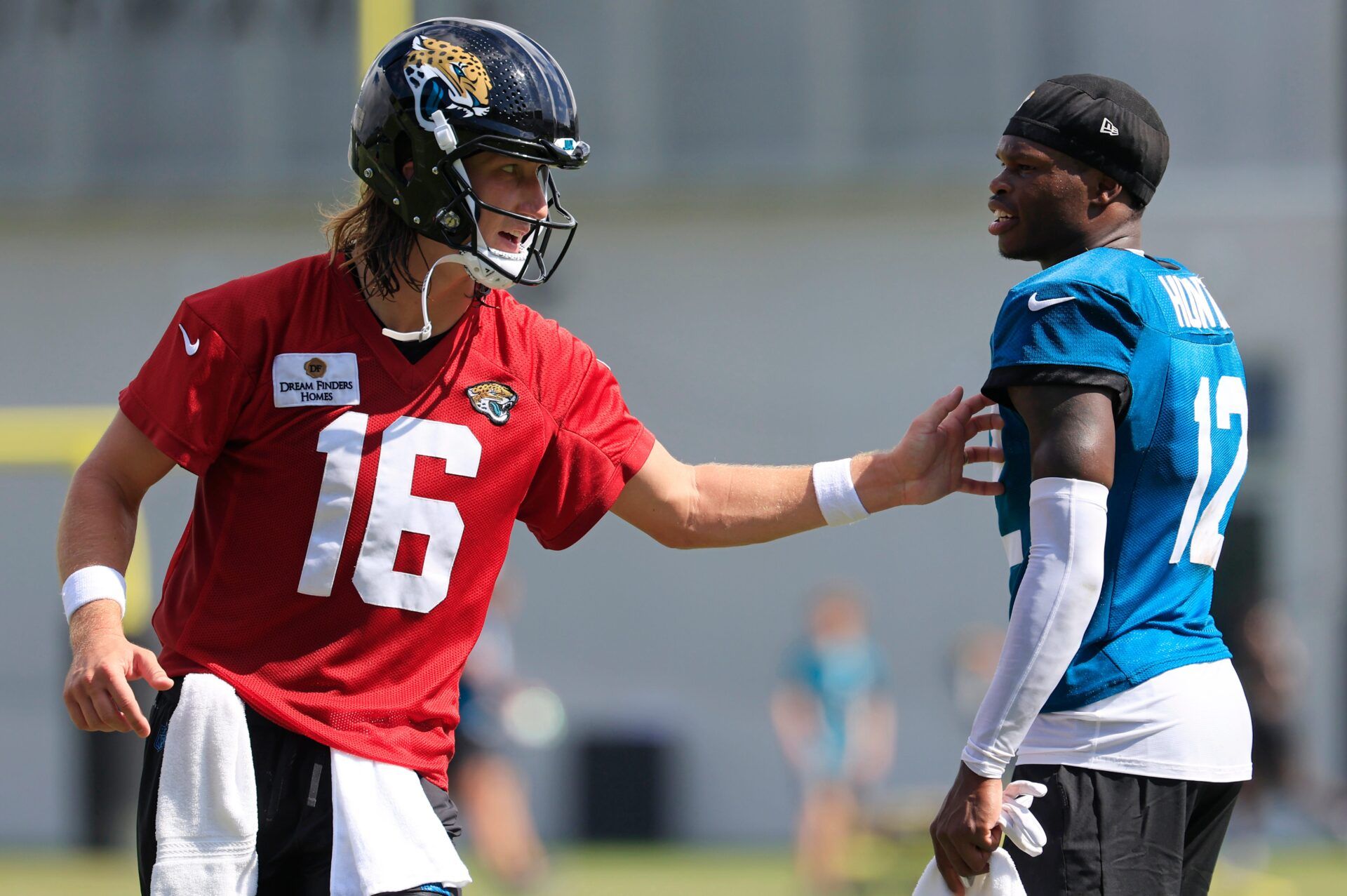 Jacksonville Jaguars quarterback Trevor Lawrence (16) talks technique with wide receiver Travis Hunter (12) after an NFL training camp session at the Miller Electric Center, Sunday, Aug. 3, 2025, in Jacksonville, Fla. [Corey Perrine/Florida Times-Union]